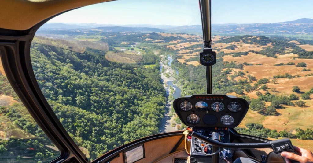 Helicopter flying over river in Napa Valley